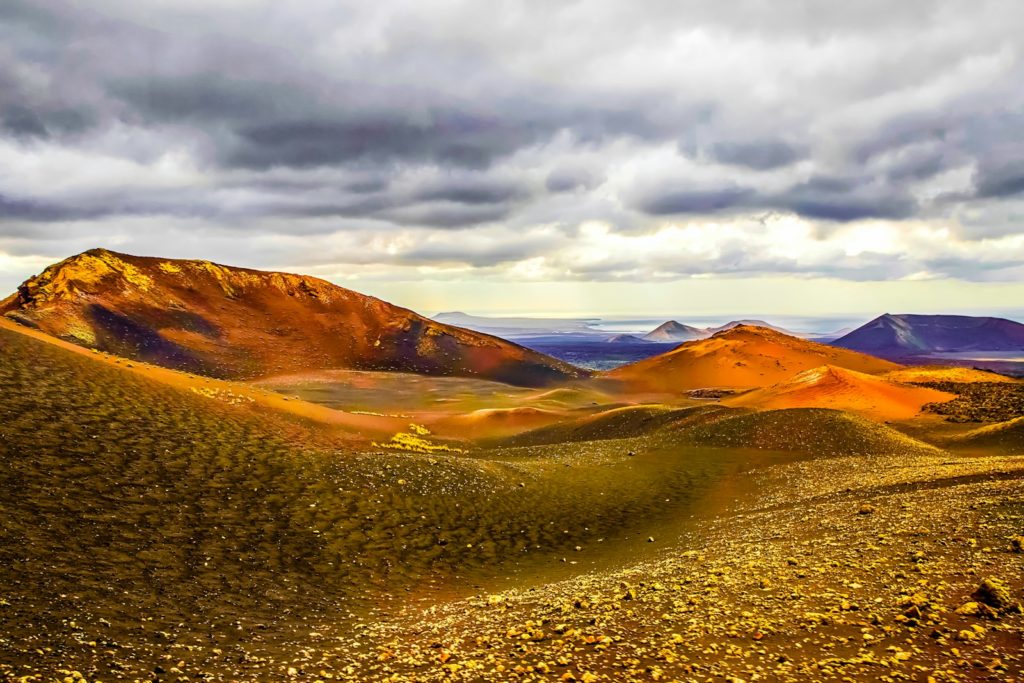 grass and soil covered field and mountains